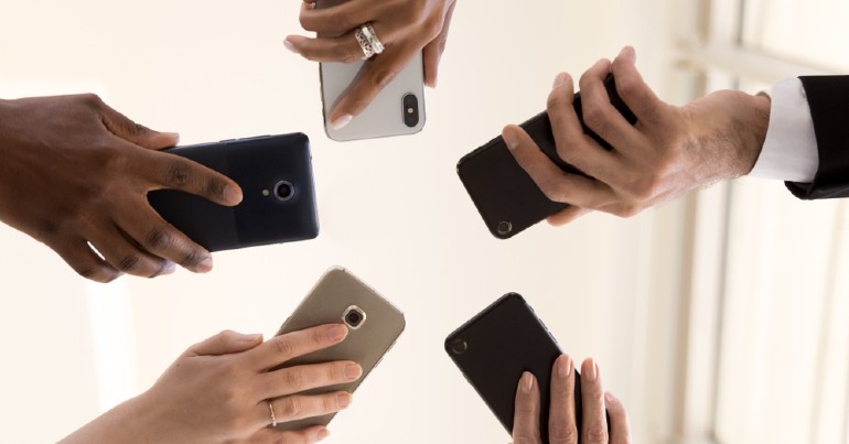 diverse hands holding smart mobile devices