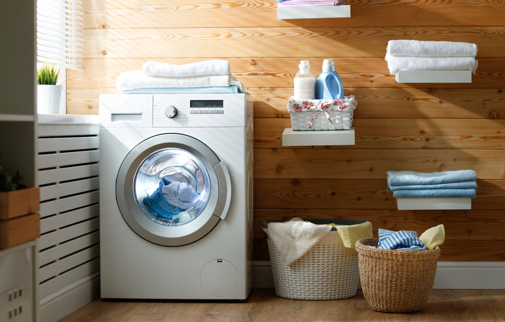 a laundry room with a basket and a washing machine