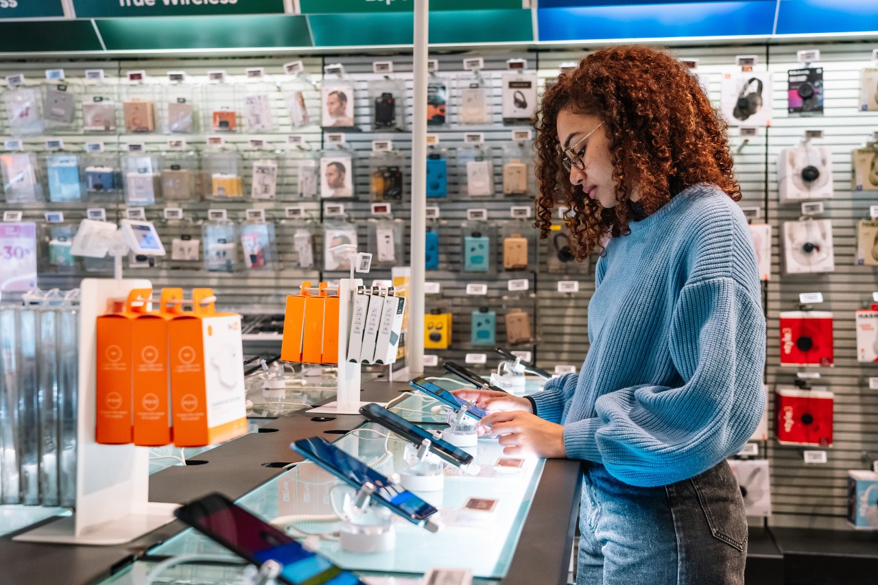 a person looking at a phones in a store