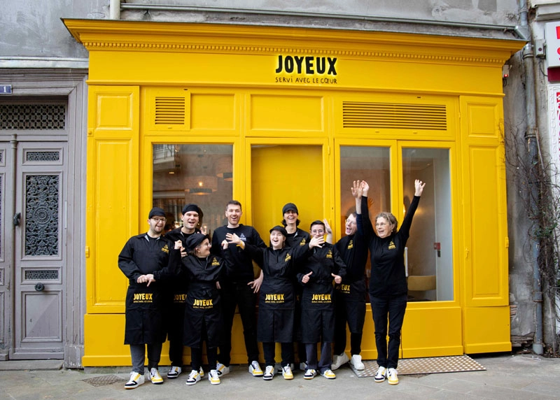a group of people posing for a photo in front of a building