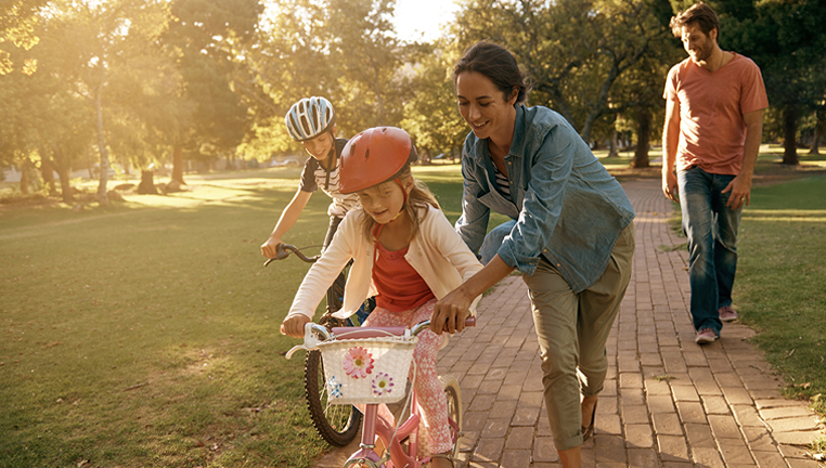 disability_and_life_card Mother teaching kids to ride bike.