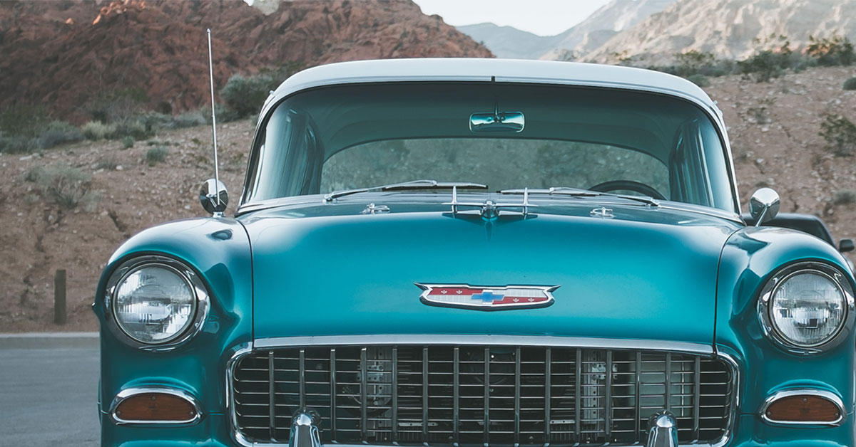 a blue car parked on a road